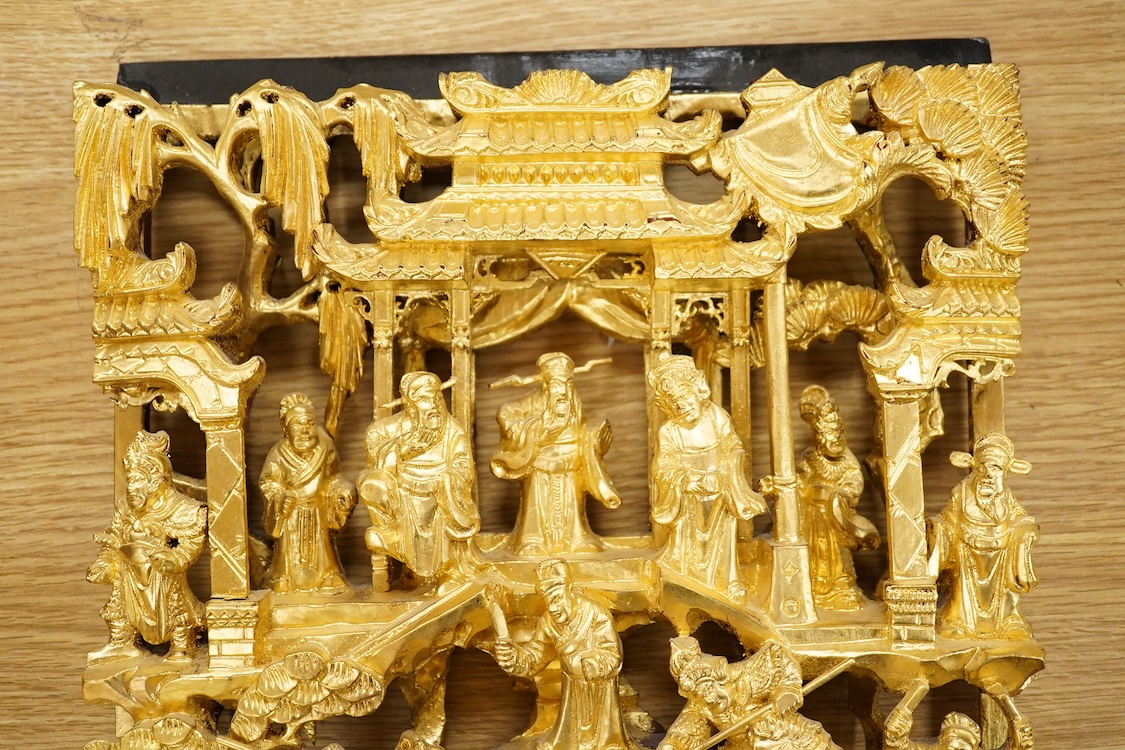 A Chinese carved gilt wood panel, depicting battle scenes, 50cm high